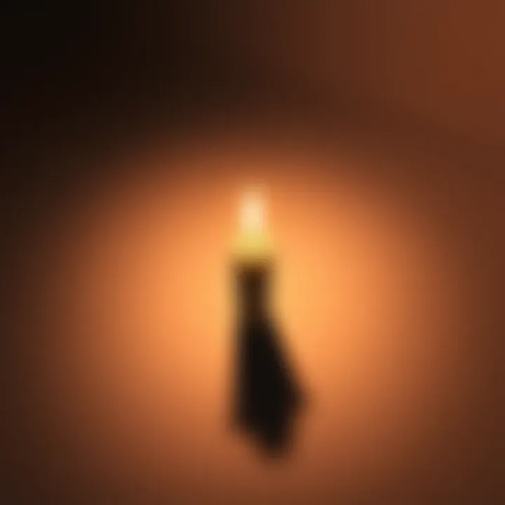 A lit candle with a long downward shadow on a surface